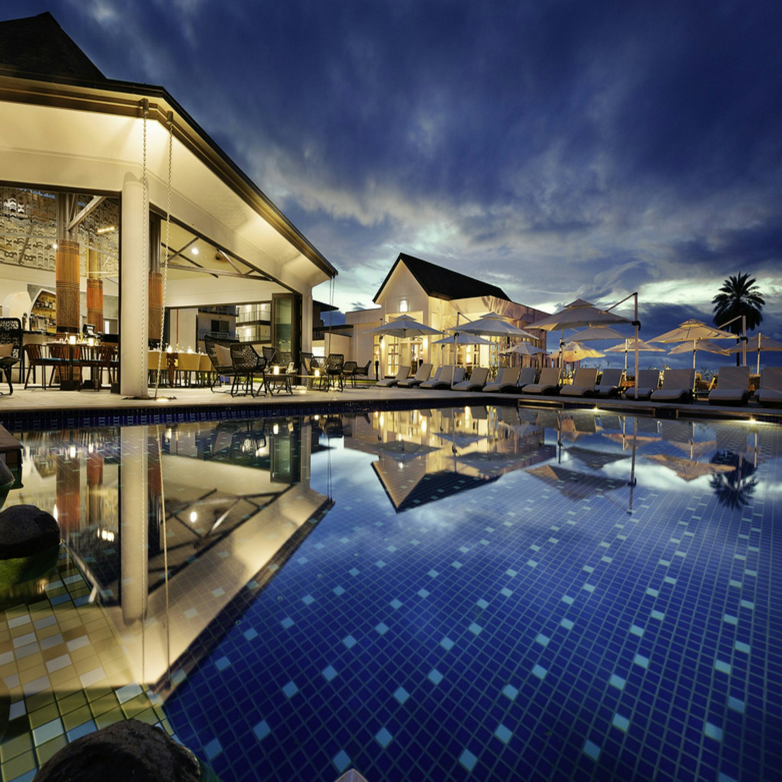 Resort-style swimming pool and sun deck at a luxury condominium amenity level